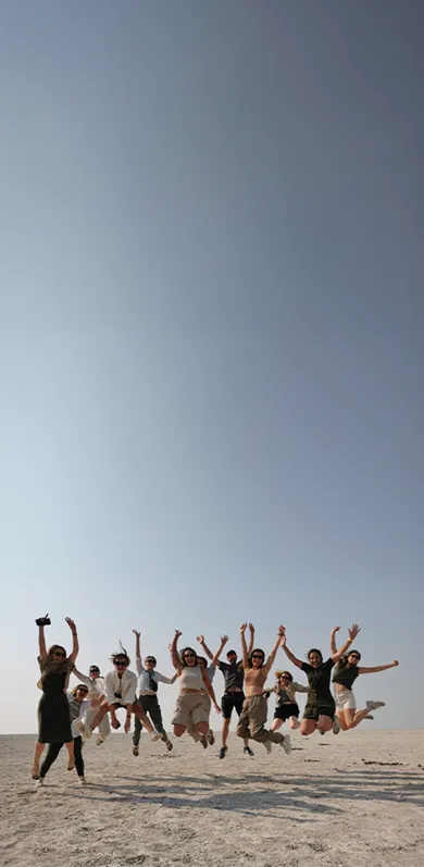 Happy guests jumping together, raising their hands and seeming to hover over the ground